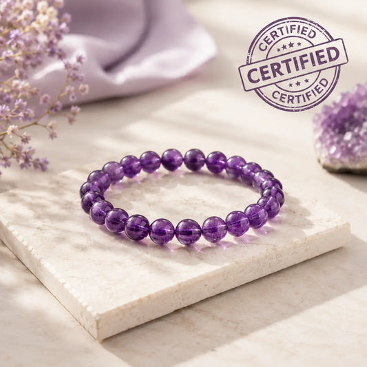 Purple beaded bracelet on a white stone surface with a 'Certified' stamp in the corner.